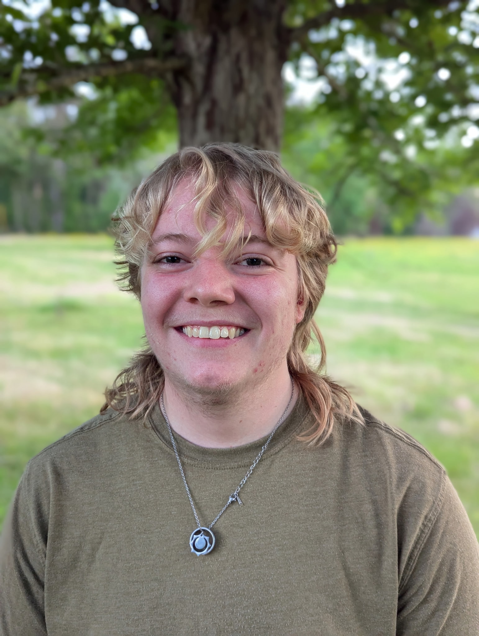 A person smiling at the camera  AI-generated content may be incorrect.
